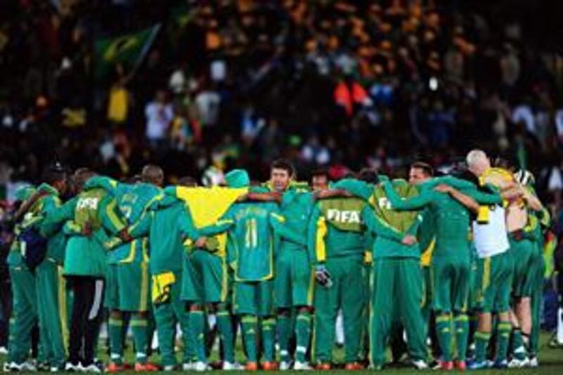 The South Africa coach Joel Santana, centre, with his players after the 1-0 loss to Brazil.