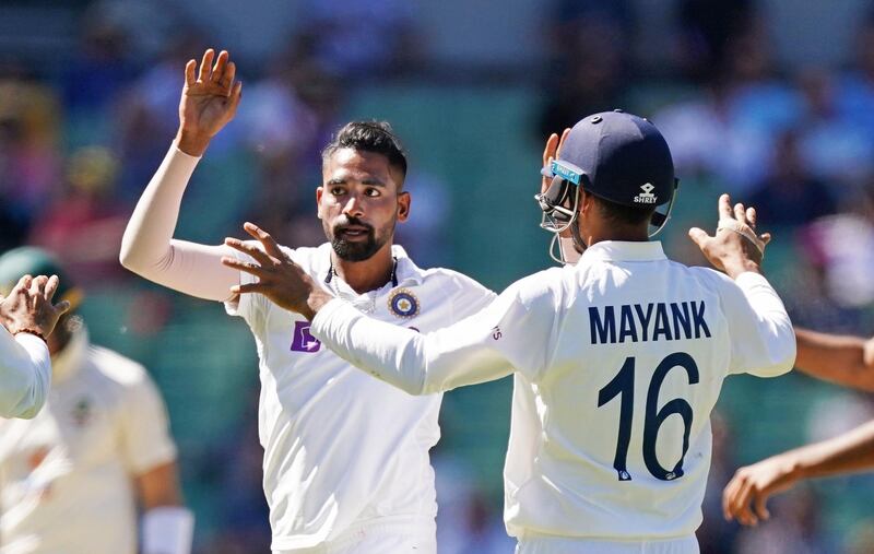 epa08904075 Mohammed Siraj (L) of India celebrates after dismissing Cameron Green of Australia of Australia during day one of the second Test Match between Australia and India at The MCG, Melbourne, Australia, 26 December 2020.  EPA/SCOTT BARBOUR IMAGES TO BE USED FOR NEWS REPORTING PURPOSES ONLY, NO COMMERCIAL USE WHATSOEVER, NO USE IN BOOKS WITHOUT PRIOR WRITTEN CONSENT FROM AAP AUSTRALIA AND NEW ZEALAND OUT
