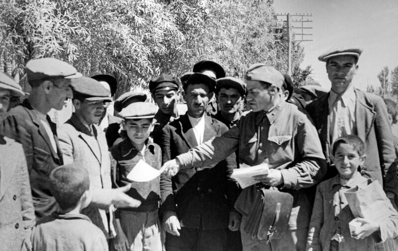 A Red Army political instructor hands out propaganda leaflets to Tabriz residents during the Anglo-Soviet invasion. The operation was also designed to protect vital oilfields. Getty Images