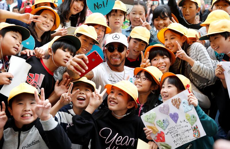 Lewis Hamilton takes a selfie with school children in Suzuka, Japan. Toru Hanai / Reuters