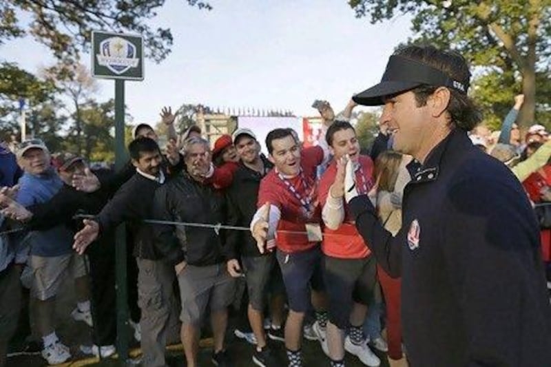 Bubba Watson high-fives fans as the American walks up the first fairway during a foursomes match at the Ryder Cup today. David J Phillip / AP Photo
