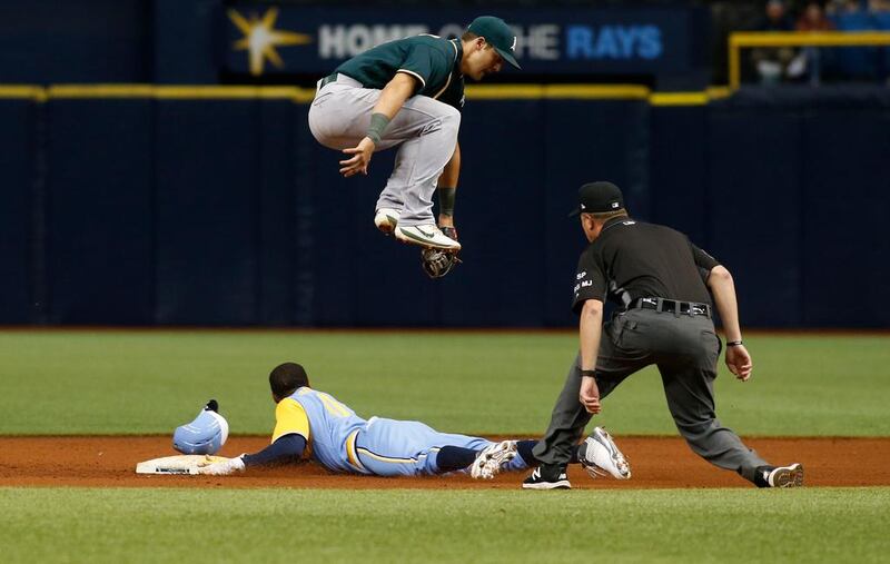 Mallex Smith of the Tampa Bay Rays steals second base as Oakland shortstop Chad Pinder jumps in the air during their baseball match in Florida.   Brian Blanco / Getty Images / AFP