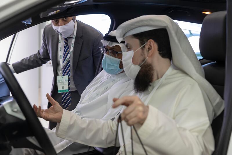 Visitors check out the UAE's first locally produced electric car, Al Damani. The vehicle is manufactured by the M Glory Group.