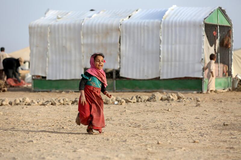 A girl walks past a tent at a camp for internally displaced people (IDPs) in Marib, Yemen April 5, 2021. Picture taken April 5, 2021. REUTERS/Ali Owidha