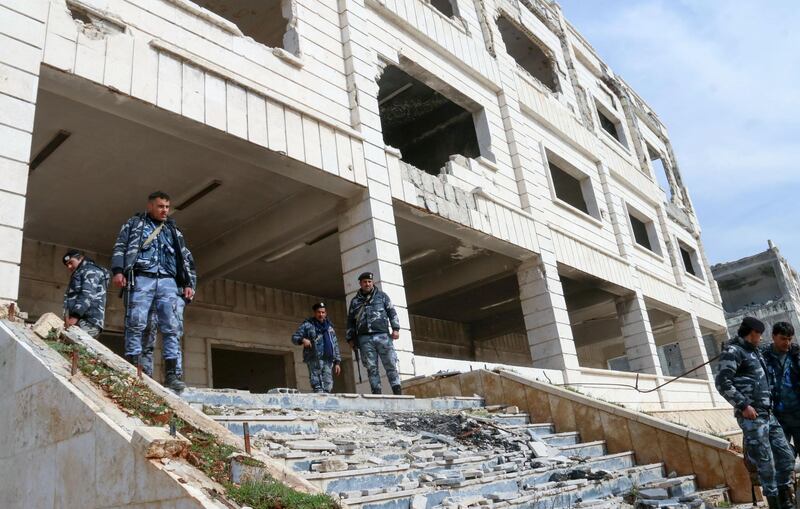 Members of the Syrian security forces take control of the police academy complex in Khan Al Asal in Aleppo province. AFP