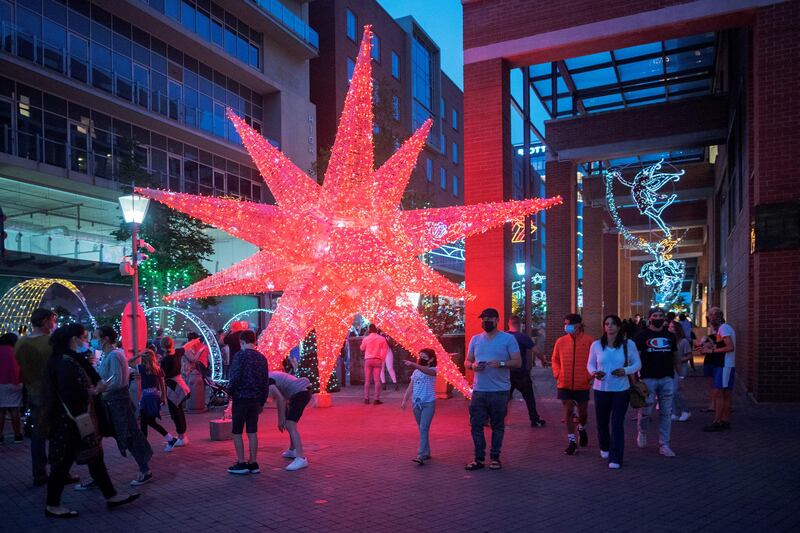 People enjoy Christmas decorations in Melrose Arch, Johannesburg, on December 21.  AFP