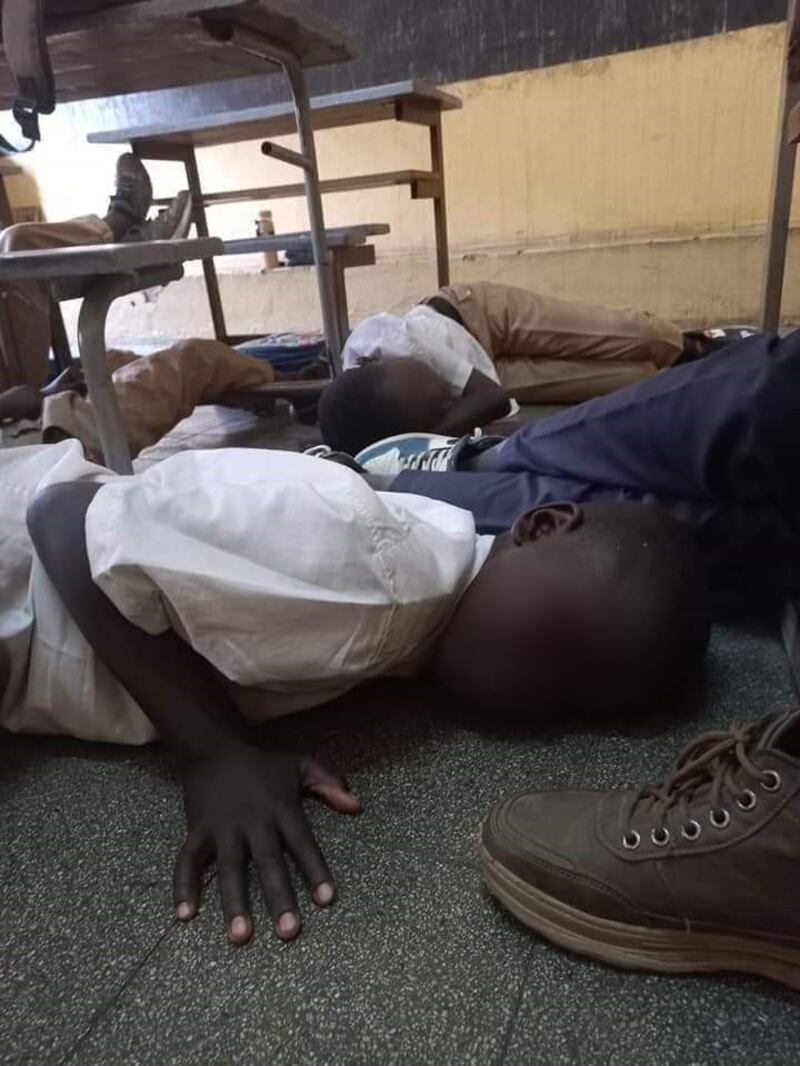 Schoolboys on the floor of their classrooms during the conflict