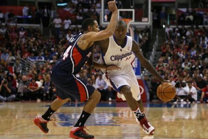 Blake Griffin of the LA Clippers, second right, goes for a shot against the LA Lakers.