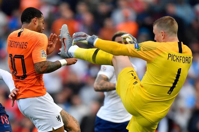 Pickford fights for the ball with Depay. AP Photo