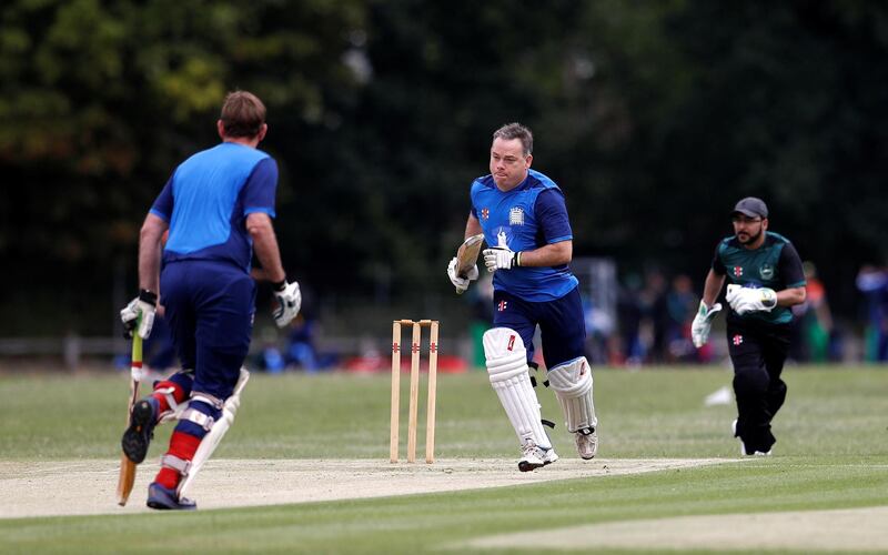 MP Nigel Adams and Charles Courtenay run between the wickets.