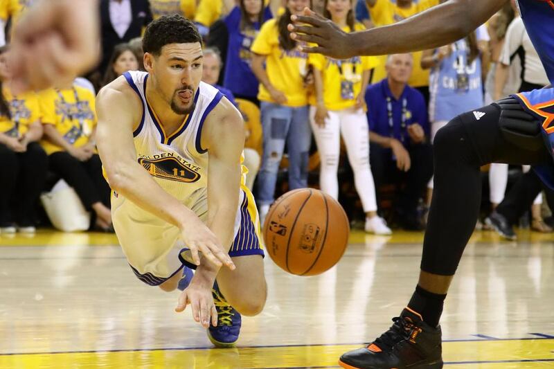 Klay Thompson #11 of the Golden State Warriors passes the ball in Game Seven of the Western Conference Finals against the Oklahoma City Thunder during the 2016 NBA Playoffs at ORACLE Arena on May 30, 2016 in Oakland, California. Ezra Shaw/Getty Images/AFP