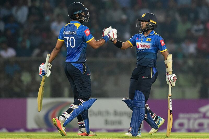 (FILES) In this file photo taken on February 18, 2018 Sri Lanka cricketer Kusal Mendis (R) celebrates with his teammate Danushka Gunathilaka (L) after scoring a half century (50 runs) during the second Twenty20 (T20) cricket match between Bangladesh and Sri Lanka at the Sylhet International Cricket Stadium in Sylhet. Sri Lanka's cricket board on June 28, 2021 pulled out three players, including vice-captain Kusal Mendis, from the upcoming one-day international tournament in England after they breached their bio-secure Covid bubble. / AFP / MUNIR UZ ZAMAN
