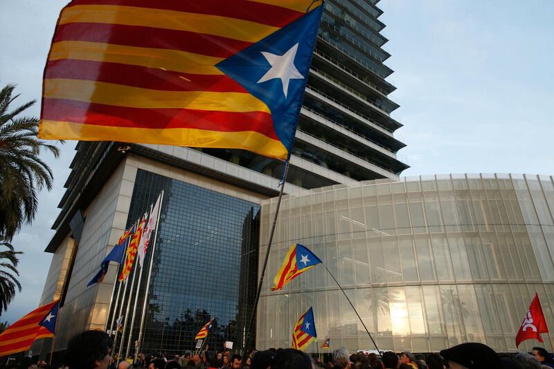 Pro-independence demonstrators waving independence flags, gather outside the German consulate to protest the detention of deposed leader of Catalonia's pro-independence party Carles Puigdemont in Barcelona, Spain, on March 25, 2018. Manu Fernandez / AP Photo