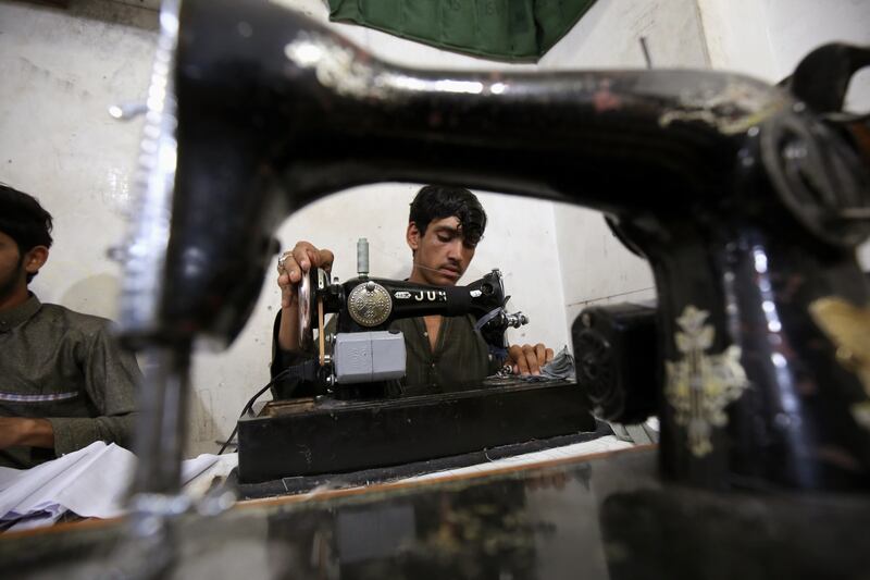 A tailor sewing garments for Eid Al Fitr in Peshawar, Pakistan. EPA