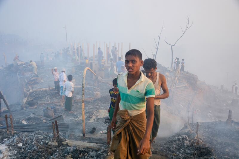 Rohingya refugees search for their belongings after a fire broke out in Balukhali refugee camp in Ukhia, Coxâ€™s bazar, Bangladesh, 05 March 2023.  According to the United Nations High Commissioner for Refugees (UNHCR) report, over 90 facilities including hospitals and learning centres were damaged as a massive fire broke out at a Rohingya camp in Cox's Bazar's Ukhiya upazila on 05 March afternoon.   EPA / STR