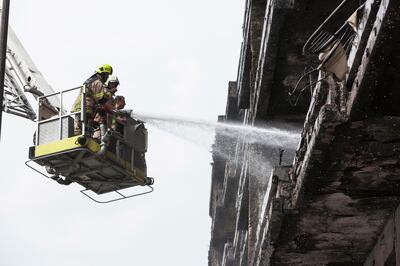 DUBAI, UNITED ARAB EMIRATES, 24 NOVEMBER 2015. Remnants of the fire that broke out in an apartment building on Muraqabat street in Deira next to the Crowne Plaza being cleaned up by Civil Defense. (Photo: Antonie Robertson/The National) ID: 77265. Journalist: Nick Webster. Section: National. *** Local Caption ***  AR_2411_Deira_After_Fire-30.JPG