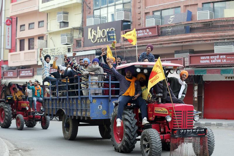 Indian farmers and youngsters shout slogans riding on tractor trolleys in a closed market during a nation-wide strike call given by various farmers' organizations as a protest against the new agricultural laws introduced by the government and to demand a roll-back of those laws, in Amritsar, India. Farmers all over India have called for a one day nationwide strike,to demand the rollback in three Agri-bills of the Central Government and new Electricity Bill 2020, stating that these are against the interest of the farmers. Thousands of farmers gathered and tried to cross the sealed New Delhi border points to hold protests against the Government's new agricultural laws. Farmers have been stopped by the police at the various points outside Delhi border which are connected with neighbouring states of Haryana and Uttar Pradesh.  EPA