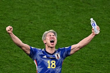 TOPSHOT - Japan's forward #18 Takuma Asano celebrates his team's win in the Qatar 2022 World Cup Group E football match between Germany and Japan at the Khalifa International Stadium in Doha on November 23, 2022.  (Photo by Anne-Christine POUJOULAT  /  AFP)