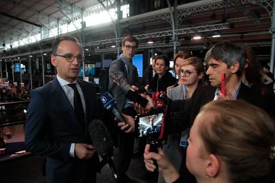 German Foreign Minister Heiko Maas answers reporters as he attends the Paris Peace Forum, Tuesday, Nov. 12, 2019 in Paris. (AP Photo/Michel Euler)
