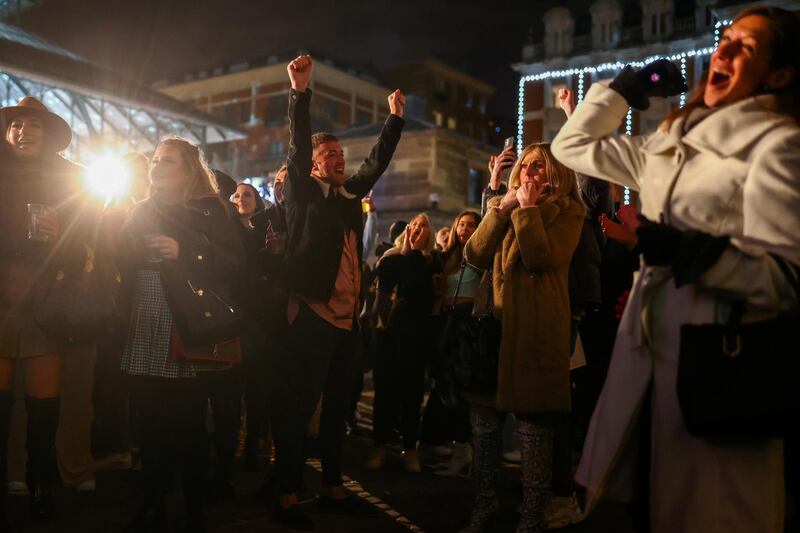 People sing and dance to Christmas songs at Covent Garden, in London. Reuters