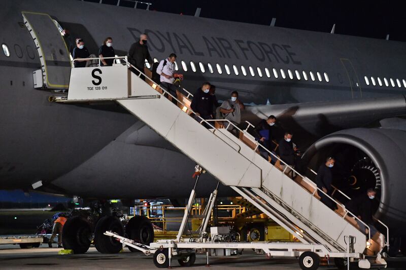 British nationals and Afghan evacuees arrive on a flight from Afghanistan at RAF Brize Norton in Oxfordshire, England.