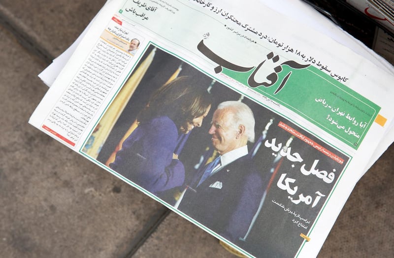 epa08807225 A copy of Iranian daily newspaper Aftab with a picture of US president elect Joe Biden and his Vice President Kamala Harris and head line 'New chapter of US' is displayed in front of a kiosk in Tehran, Iran, 08 November 2020. Media reported that Iranian President Rouhani on 08 November expressed his hopes that the next US administration will return to the nuclear deal and make up the past three years mistakes towards Iran. Biden defeated incumbent US President Donald J. Trump.  EPA/ABEDIN TAHERKENAREH