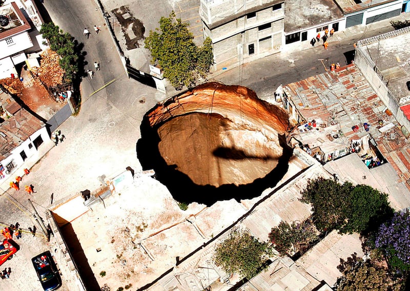 In 2007, the country's largest sinkhole, pictured, swallowed homes and a lorry and killed three people when the ground suddenly gave way. EPA