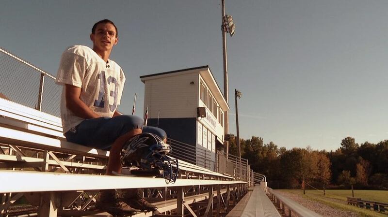 Cambridge Springs high school American football player Kris Silbaugh poses on the bleachers during an interview at practice in Cambridge Springs, Pa. Silbaugh, born without a left hand, is the teams starting wide receiver, punter and defensive back.  Joshua Replogle / AP Photo
