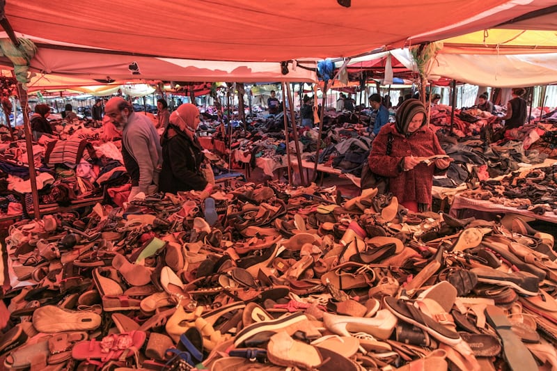 Shoppers browse shoes for sale at a second-hand clothing market in the Ettadhamen district of Tunis, on April 8, 2022.  Photo: Bloomberg