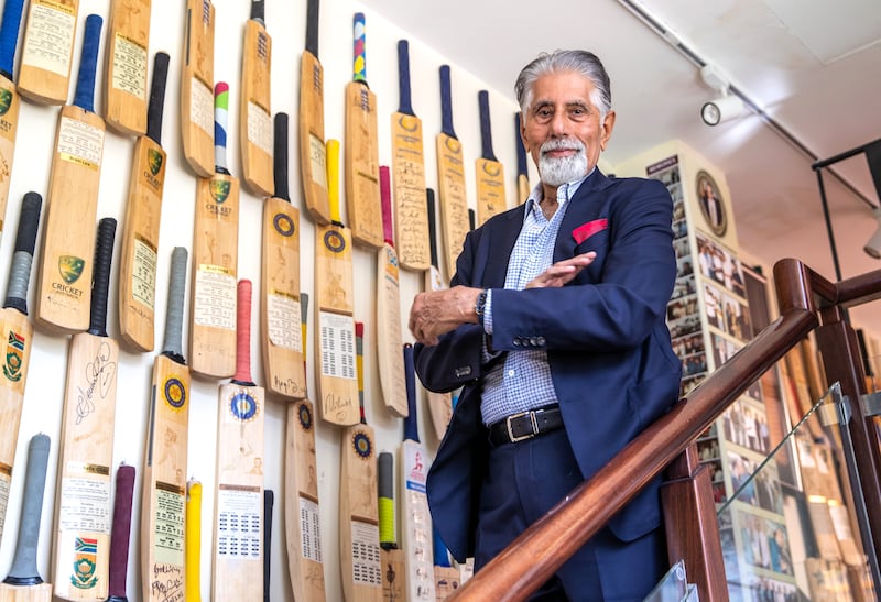 Shayam Bhatia poses next to cricket memorabilia on display at his private museum in Dubai.