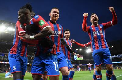 MANCHESTER, ENGLAND - JANUARY 18: Wilfried Zaha of Crystal Palace celebrates with James McCarthy of Crystal Palace and James McArthur of Crystal Palace after Fernandinho of Manchester City (not pictured) scored an own-goal which resulted in the second goal for Crystal Palace during the Premier League match between Manchester City and Crystal Palace at Etihad Stadium on January 18, 2020 in Manchester, United Kingdom. (Photo by Michael Regan/Getty Images)