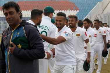 Sri Lankan and Pakistani players shake hands after exchanging caps ahead of the first Test match between Pakistan and Sri Lanka, in Rawalpindi, Pakistan. AP