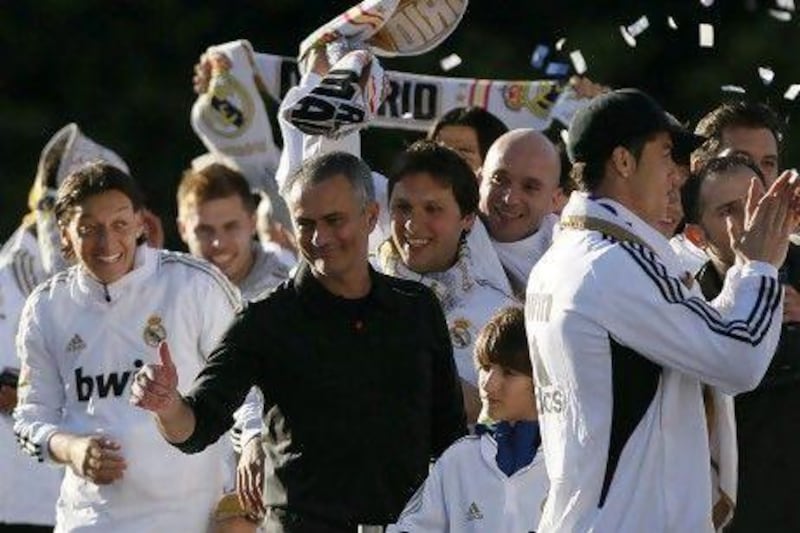 Jose Mourinho, centre, celebrates with his players at Cibeles square in Madrid on Thursday after Real won the Spanish title a day earlier. Andres Kudacki / AP Photo