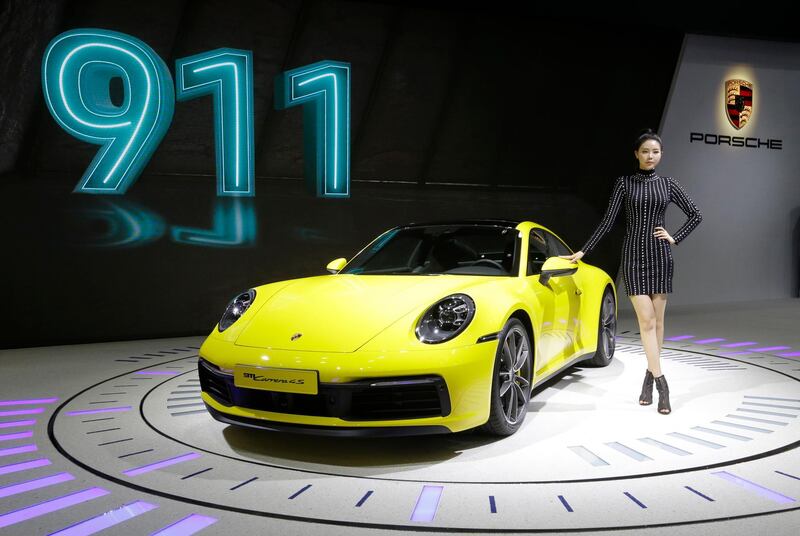 A model poses with a Porsche 911 Carrera 4S. Ahn Young-Joon / AP