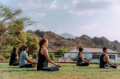 Yoga on the grounds of the Hatta Fort Hotel. Courtesy JA Hatta Fort Hotels