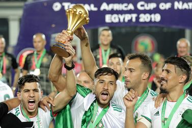 Algeria's players celebrates with the trophy at the end of the African Cup of Nations final against Senegal in Cairo on Friday night. Hassan Ammar ? AP Photo