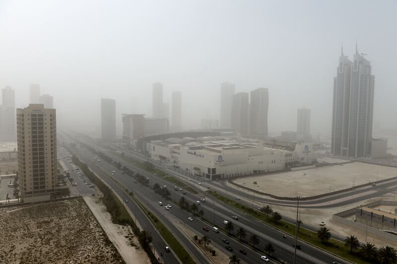 Cars drive on a highway in the Seef district during a dust storm in Bahrain's capital Manama. AFP