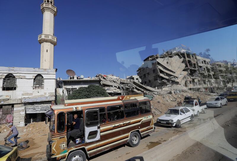 Motorists pass by in Damascus. AP