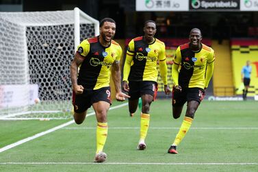 Soccer Football - Premier League - Watford v Newcastle United - Vicarage Road, Watford, Britain - July 11, 2020 Watford's Troy Deeney celebrates scoring their second goal from the penalty spot with teammates, as play resumes behind closed doors following the outbreak of the coronavirus disease (COVID-19) Pool via REUTERS/Richard Heathcote EDITORIAL USE ONLY. No use with unauthorized audio, video, data, fixture lists, club/league logos or 'live' services. Online in-match use limited to 75 images, no video emulation. No use in betting, games or single club/league/player publications. Please contact your account representative for further details.