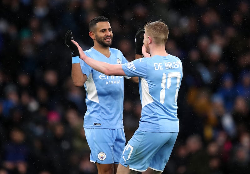 Manchester City's Riyad Mahrez, left, celebrates scoring his side's fourth goal in the FA Cup fourth round against Fulham at the Etihad Stadium on Saturday, February 5, 2022. PA