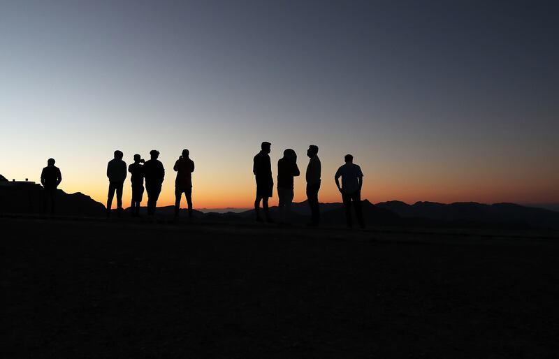 Visitors enjoy the sunrise on Jebel Jais in Ras Al Khaimah. Pawan Singh / The National