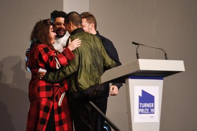 MARGATE, ENGLAND - DECEMBER 03:   (L-R) Tai Shani, Oscar Murillo Helen Cammock and Lawrence Abu Hamdan celebrate after being announced as the joint winners of Turner Prize 2019 by Edward Enninful, Editor-in-Chief of British Vogue in Margate. (Photo by Stuart C. Wilson/Stuart Wilson/Getty Images for Turner Contemporary)