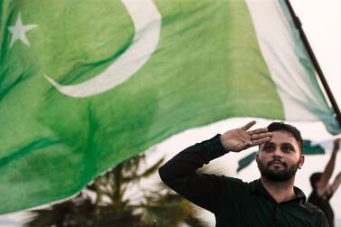A man marks Pakistan's independence day at the Corniche in Abu Dhabi. The country's completed pavilion for the Dubai Expo 2020 was handed over on Sunday. Victor Besa  / The National