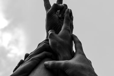 In this photo, Amir Hazim asked a group of protestors to put their hands together as a symbol of unity and peace. 'I like the idea of people who don't know each other having one goal,' says the photographer. Amir Hazim