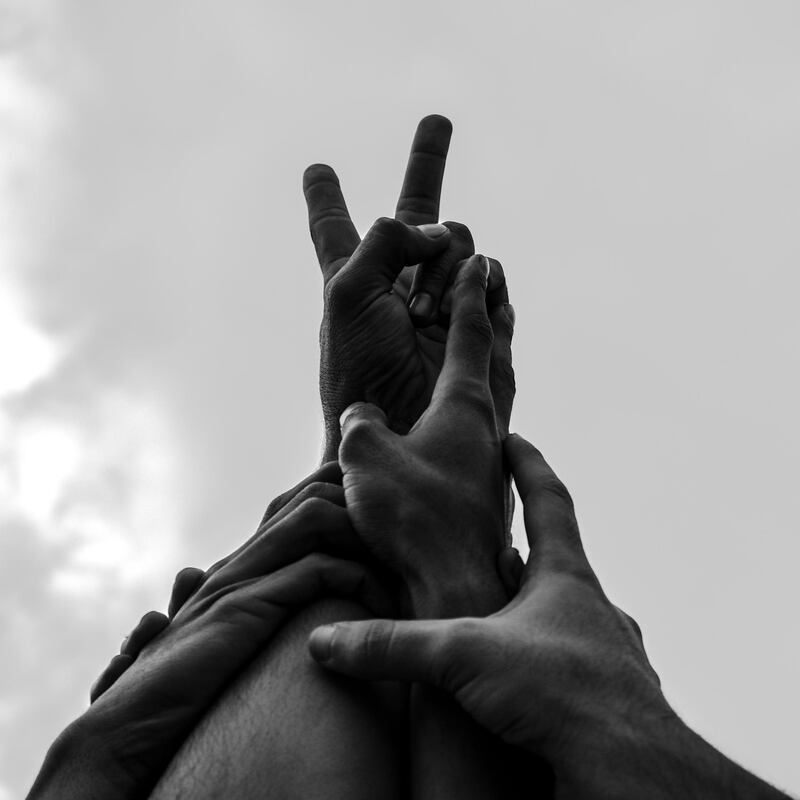 In this photo, Amir Hazim asked a group of protestors to put their hands together as a symbol of unity and peace. 'I like the idea of people who don't know each other having one goal,' says the photographer. Amir Hazim