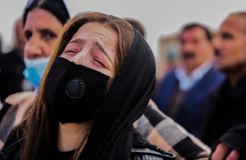 A woman reacts during a a mass funeral for Yazidi victims of the Islamic State (IS) group in the northern Iraqi village of Kojo in Sinjar district. AFP