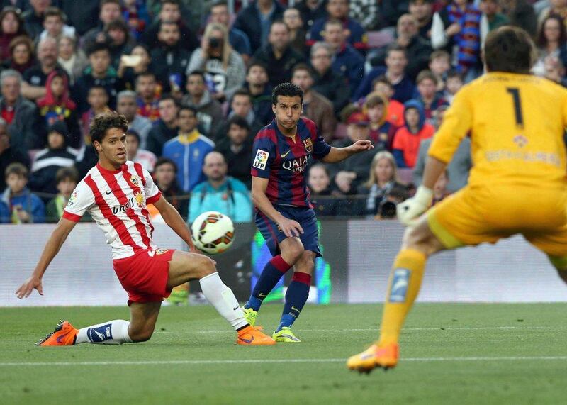 Barcelona's Pedro curls a pass on Wednesday in Barca's La Liga win over Almeria at the Camp Nou. Toni Albir / EPA / April 8, 2015