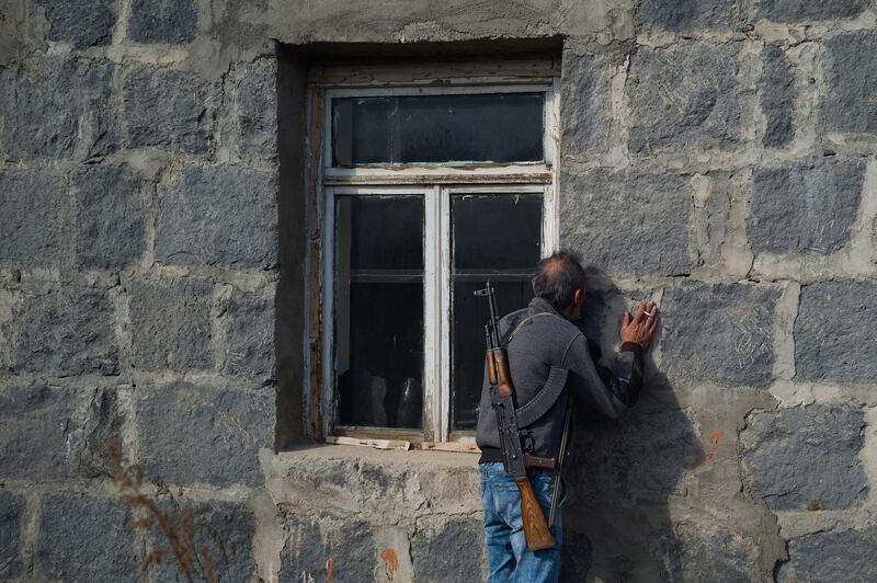 A man kisses the walls of his home before abandoning it as fear of Azeri persecution prompts him to leave his homeland in Karvachar, Nagorno-Karabakh. Getty Images
