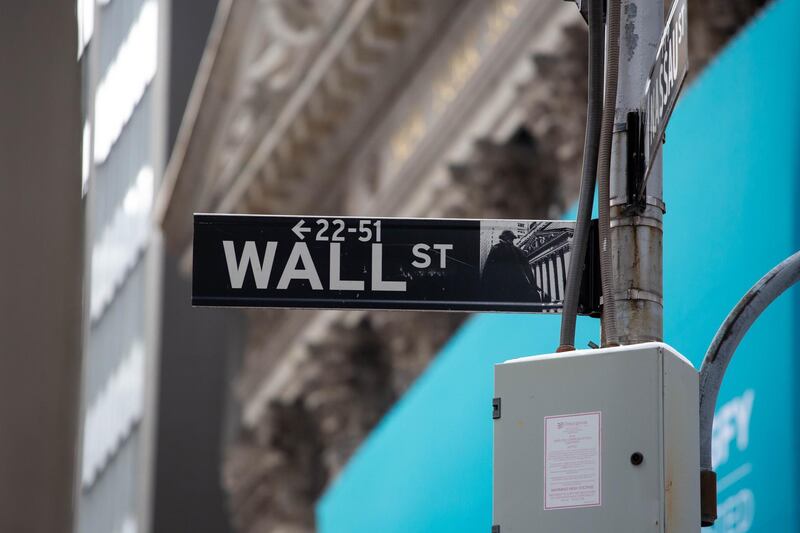 A Wall Street street sign is displayed in front of the New York Stock Exchange (NYSE) in New York, U.S., on Thursday, Feb. 11, 2021. Signify Health Inc. opened trading at $32 after its $564 million IPO priced at $24 per share, above its $20 to $21 offering range. Photographer: Michael Nagle/Bloomberg