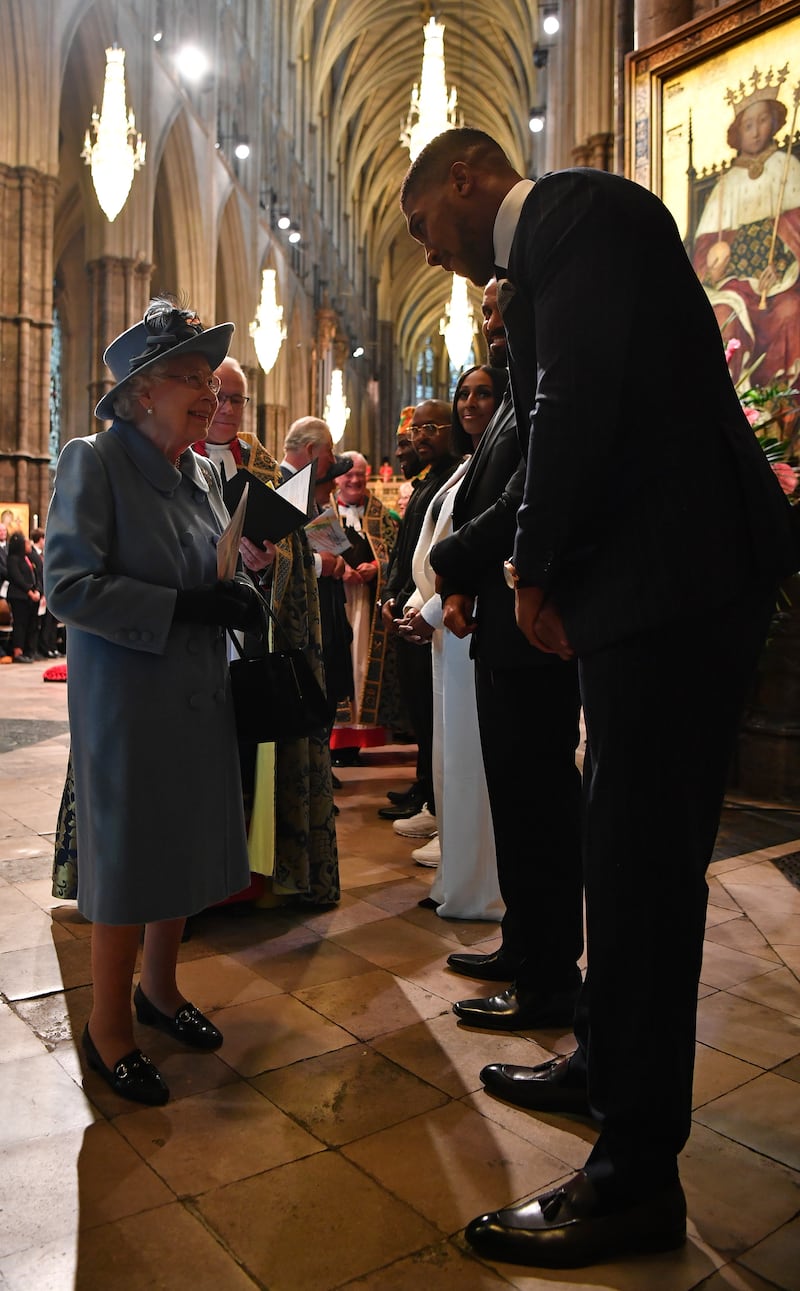 Queen Elizabeth talks to British boxer Anthony Joshua at the Commonwealth Day Service in 2020. Getty Images